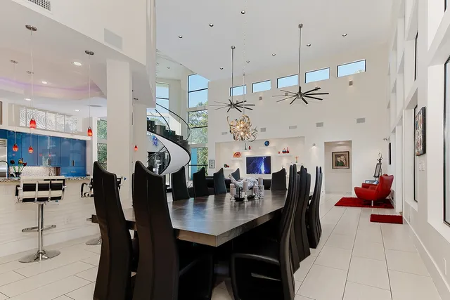 a view of a dining room with furniture and a chandelier