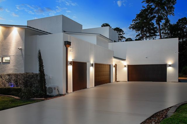a view of a building with a garage and yard