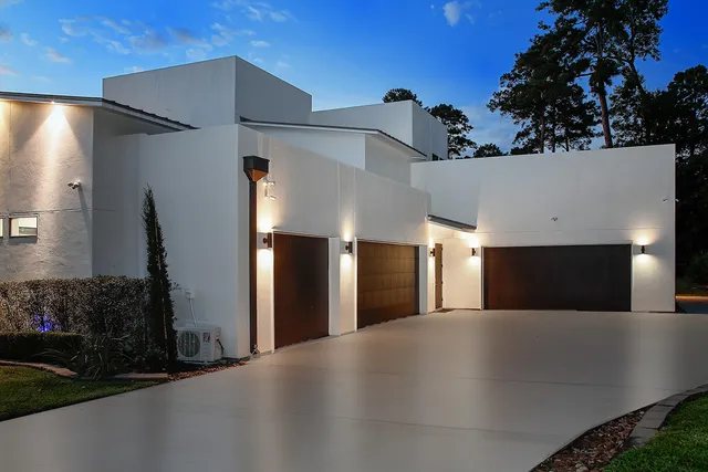 a view of a building with a garage and yard