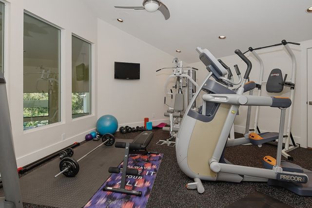 a room with gym equipment and windows