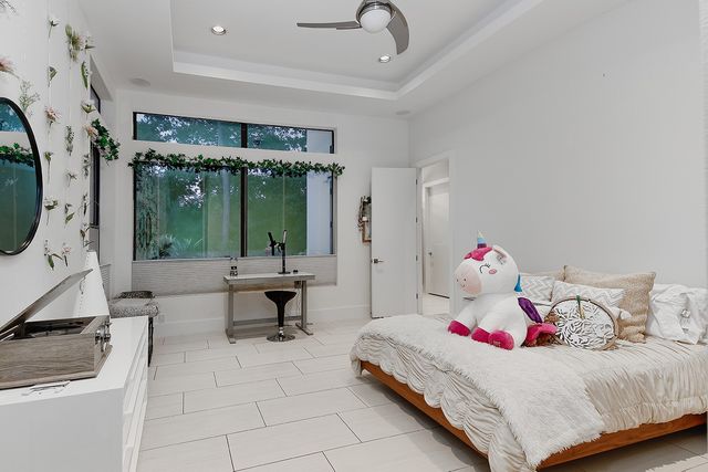 a bedroom with a bed and a chandelier