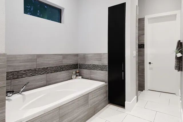 a bathroom with a bathtub and a shower