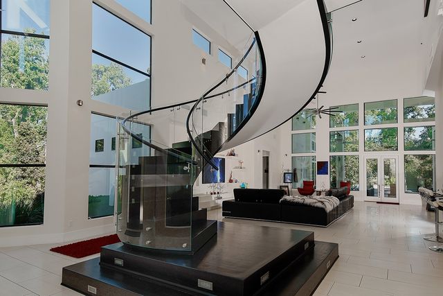 a living room with furniture fireplace and a large window