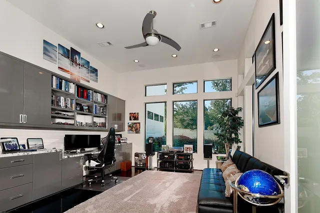 a living room with furniture a fireplace and a large window