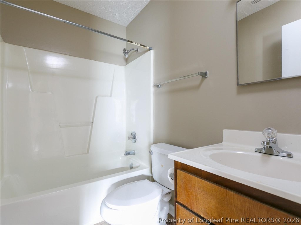 115 Eulon Loop, Unit A Raeford, NC 28376 - Photo 7 of 16 a bathroom with a sink a toilet and shower