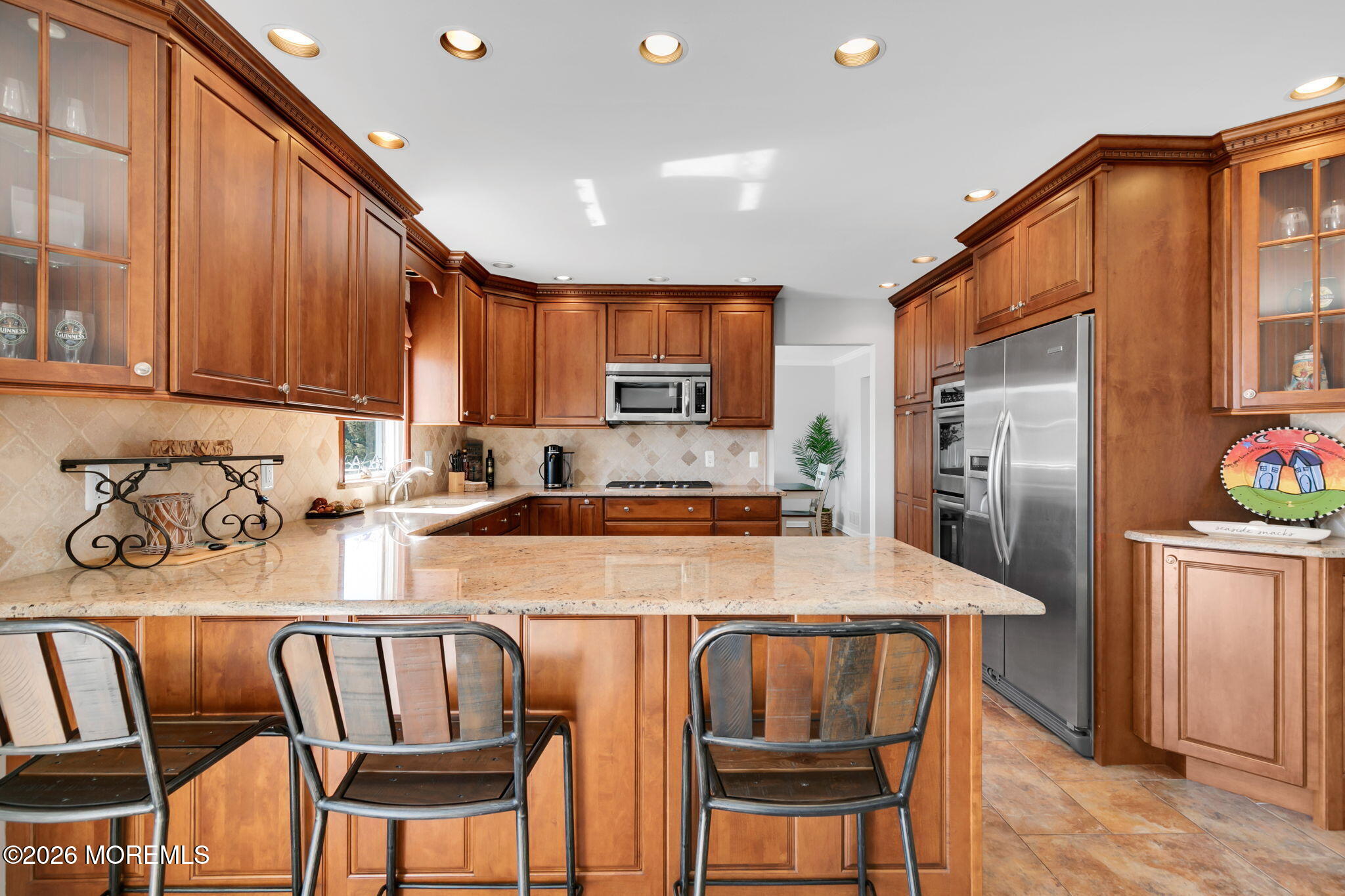 327 Tide Pond Road Mantoloking, NJ 08738 - Photo 17 of 45 a kitchen with stainless steel appliances granite countertop a table chairs sink refrigerator and cabinets