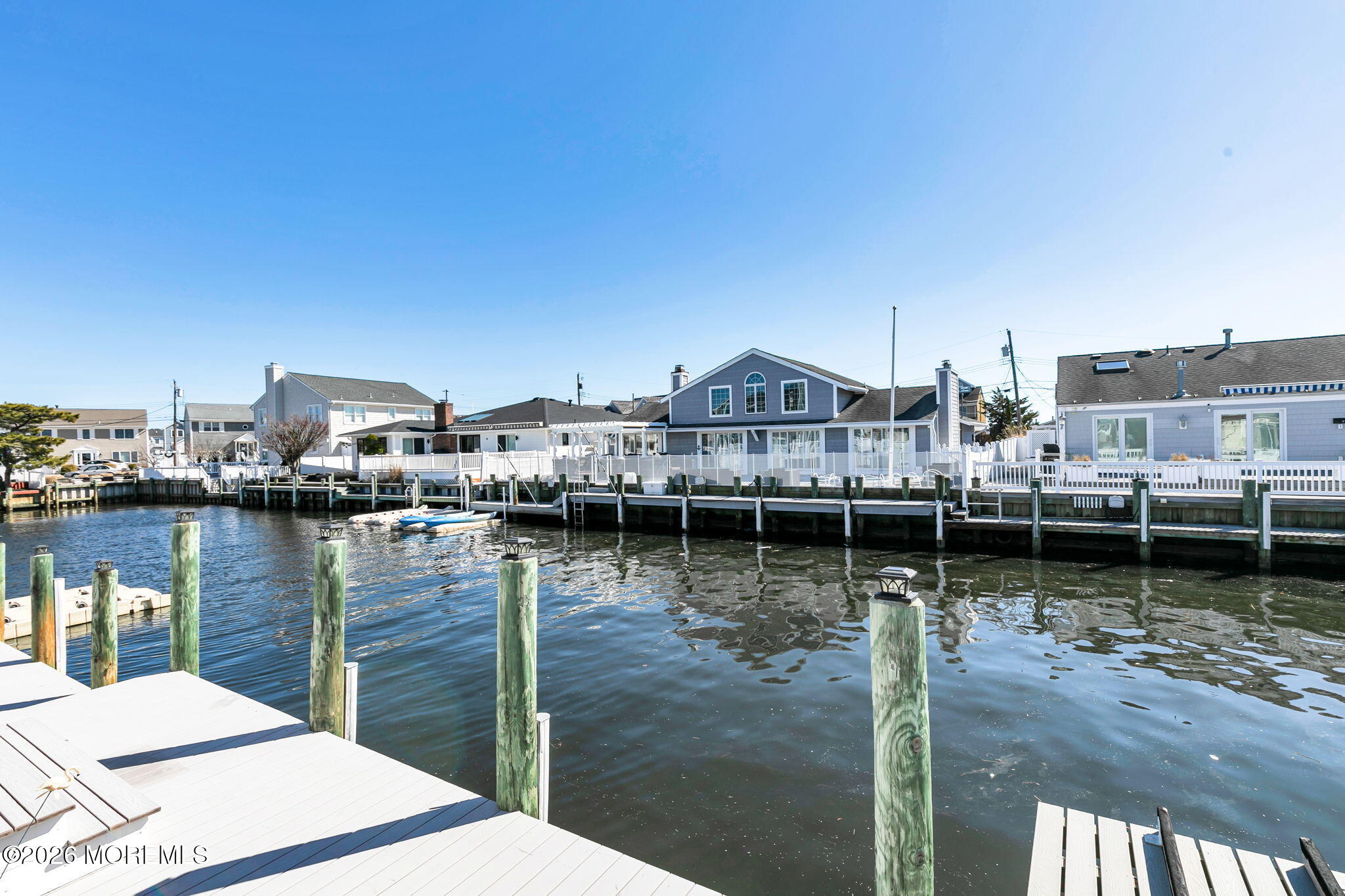 327 Tide Pond Road Mantoloking, NJ 08738 - Photo 38 of 45 a view of a lake with boats and large trees