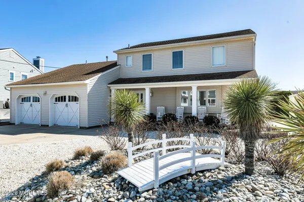 a front view of a house with a yard covered in snow