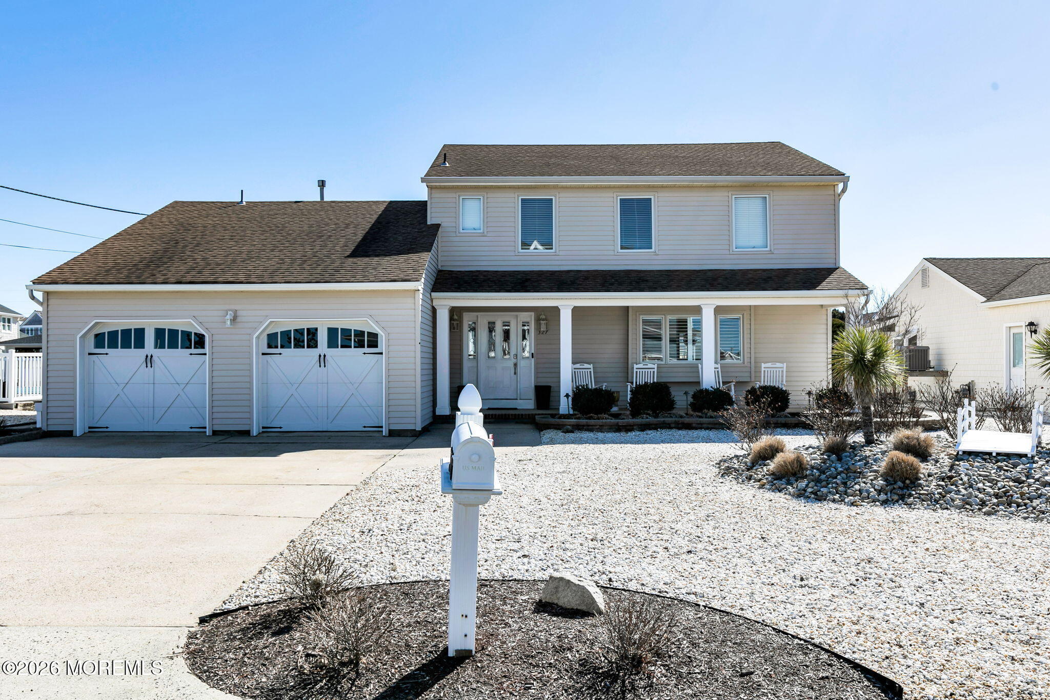 327 Tide Pond Road Mantoloking, NJ 08738 - Photo 5 of 45 a front view of a house with a yard covered in snow