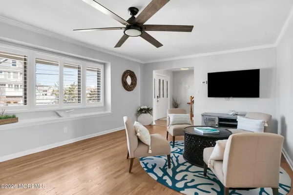a living room with furniture and a wooden floor