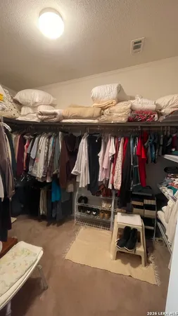 an aerial view of house with outdoor space and trees all around