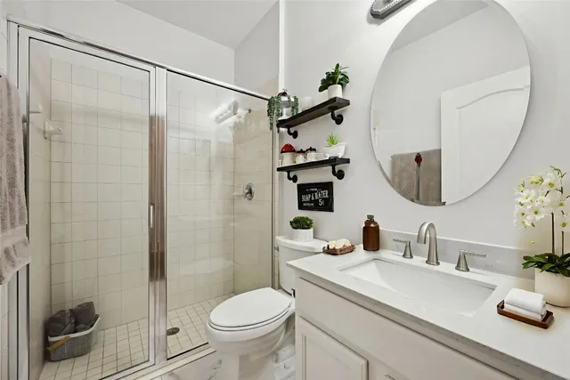 a bedroom with a bed and a potted plant