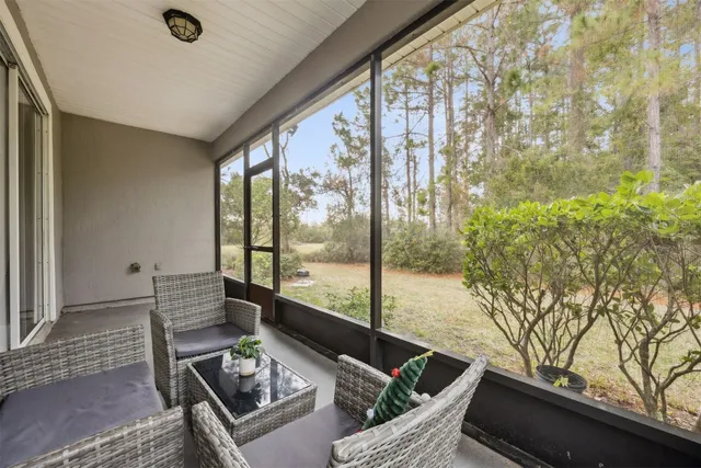 a living room with furniture and floor to ceiling window