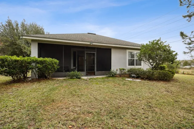 a view of a yard with plants and trees