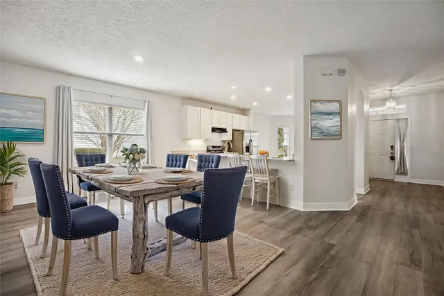a view of a dining room with furniture and wooden floor