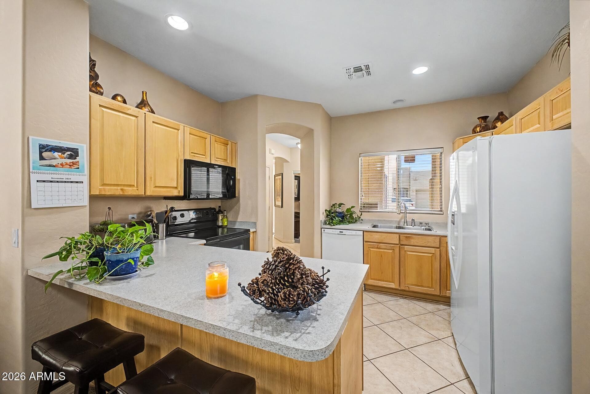 1650 South Crismon Road, Unit 25 Mesa, AZ 85209 - Photo 11 of 33 a kitchen with sink refrigerator and stove