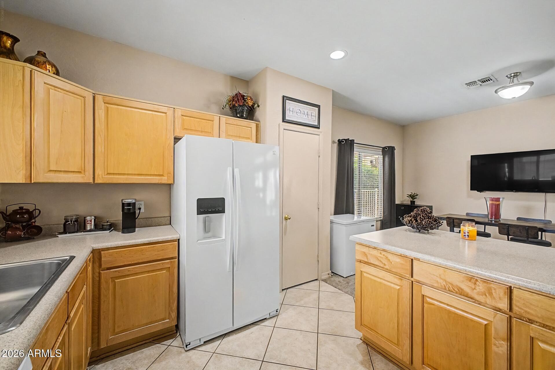 1650 South Crismon Road, Unit 25 Mesa, AZ 85209 - Photo 15 of 33 a kitchen with stainless steel appliances a stove refrigerator sink and cabinets
