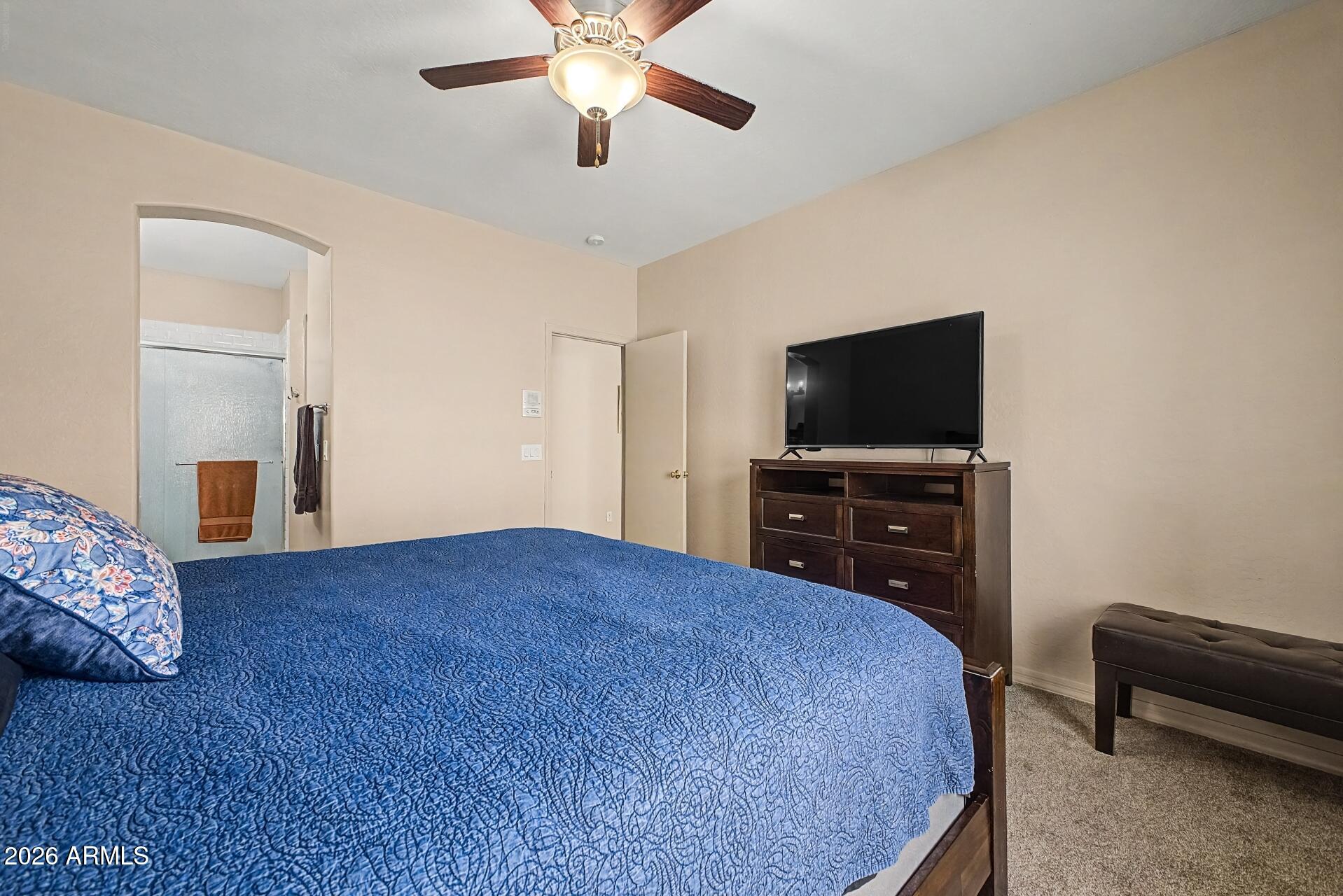 1650 South Crismon Road, Unit 25 Mesa, AZ 85209 - Photo 17 of 33 a bedroom with a bed and a television