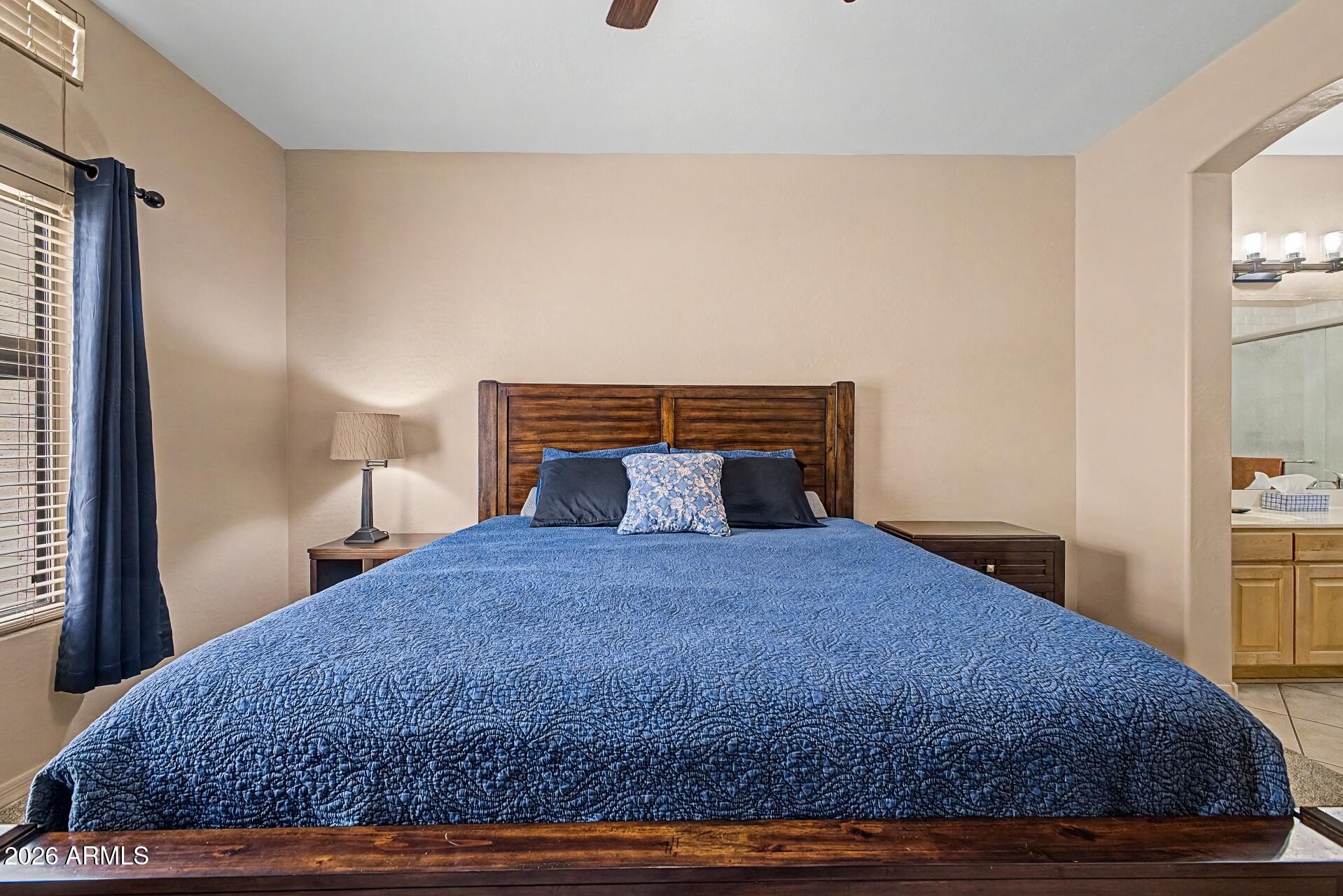1650 South Crismon Road, Unit 25 Mesa, AZ 85209 - Photo 18 of 33 a bedroom with a bed and dresser