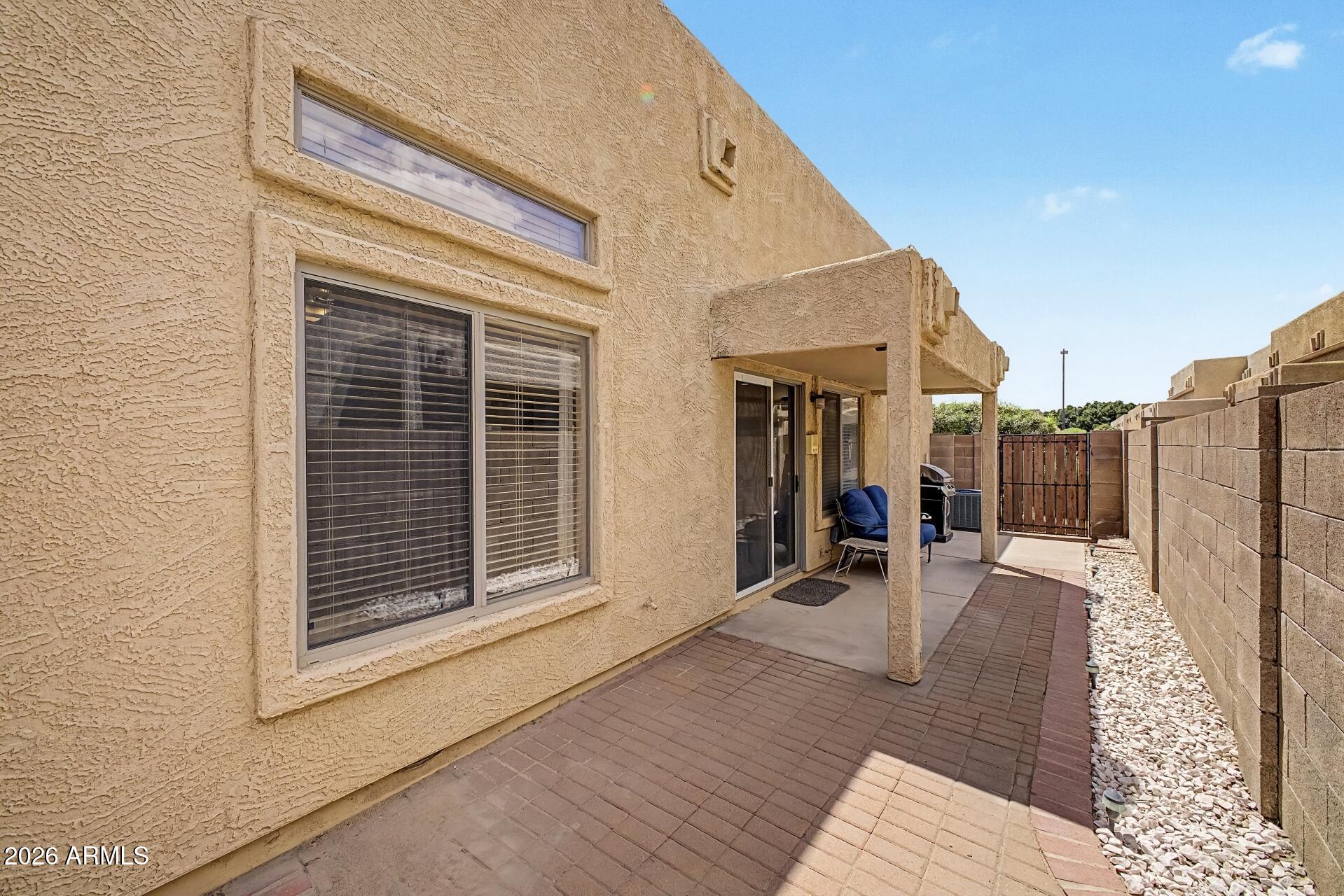 1650 South Crismon Road, Unit 25 Mesa, AZ 85209 - Photo 28 of 33 a view of living area with wooden floor and fence