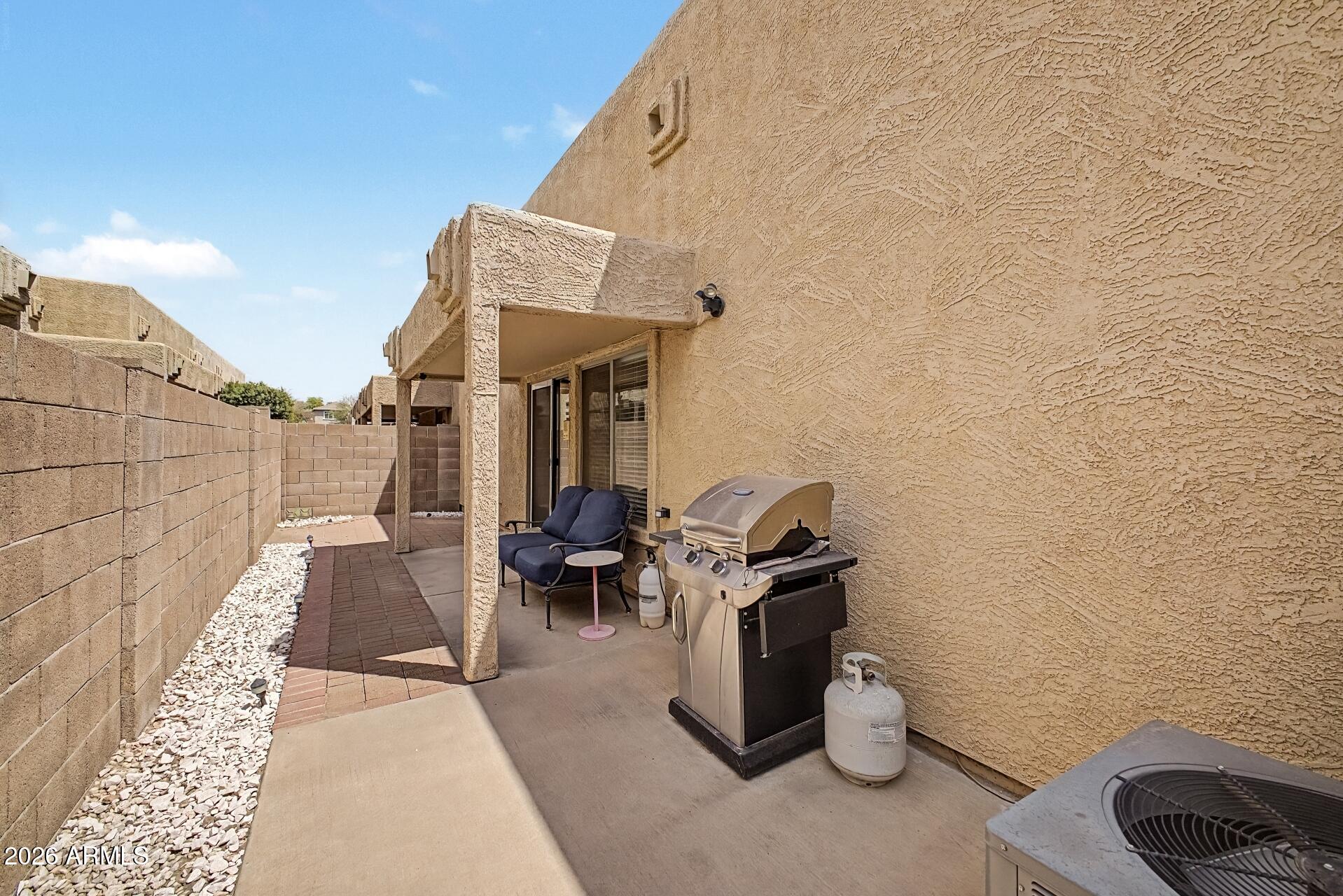 1650 South Crismon Road, Unit 25 Mesa, AZ 85209 - Photo 29 of 33 a view of a patio with table and chairs and potted plants