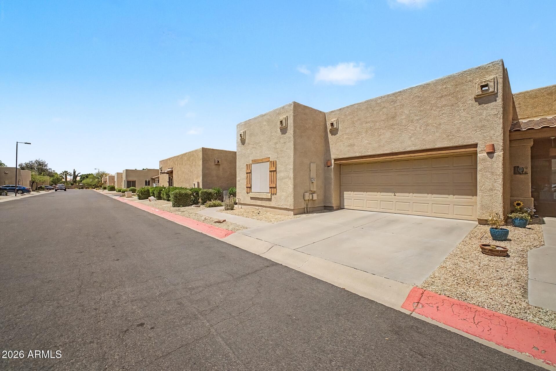 1650 South Crismon Road, Unit 25 Mesa, AZ 85209 - Photo 3 of 33 a view of a street with house