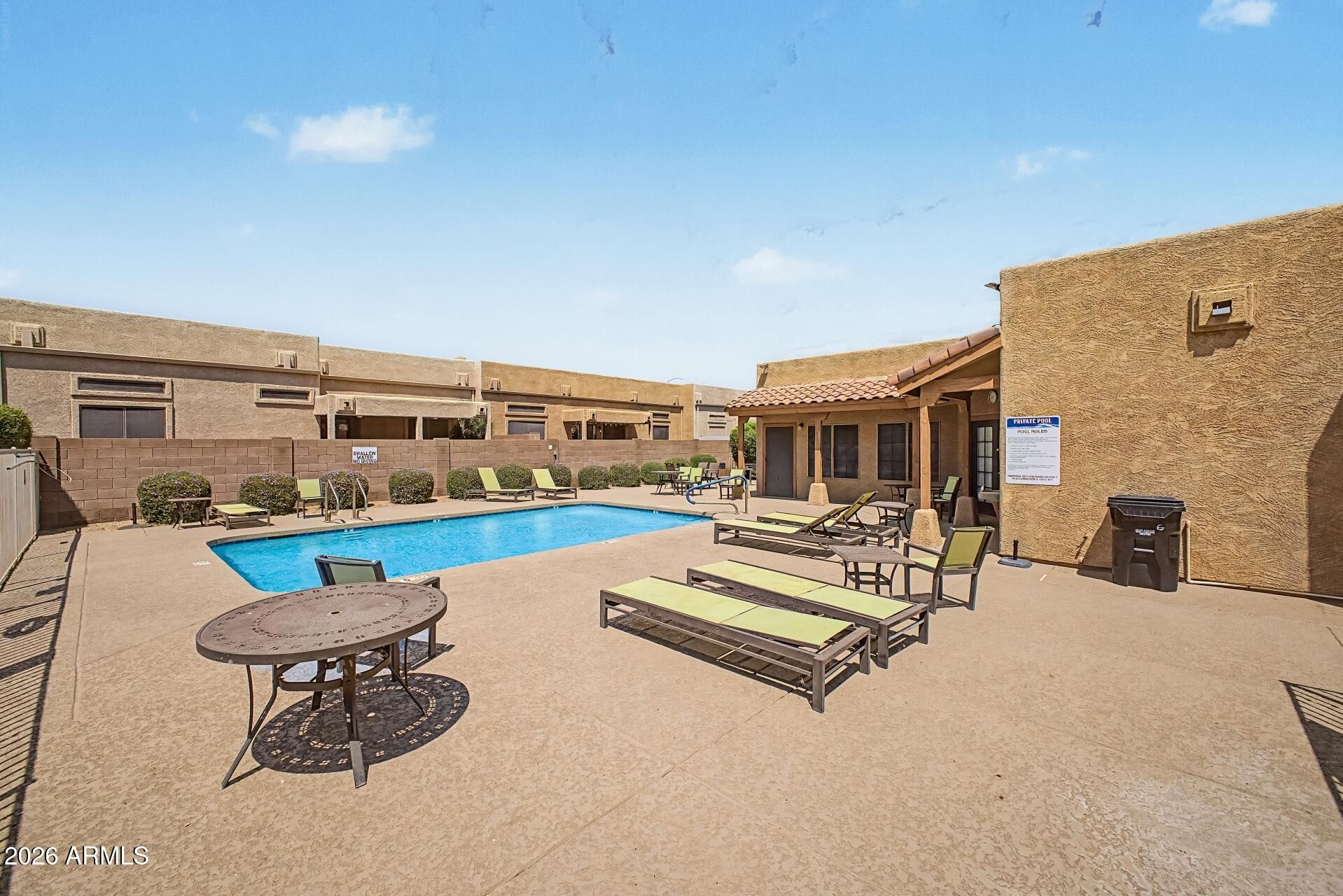 1650 South Crismon Road, Unit 25 Mesa, AZ 85209 - Photo 31 of 33 a view of a patio with a table and chairs