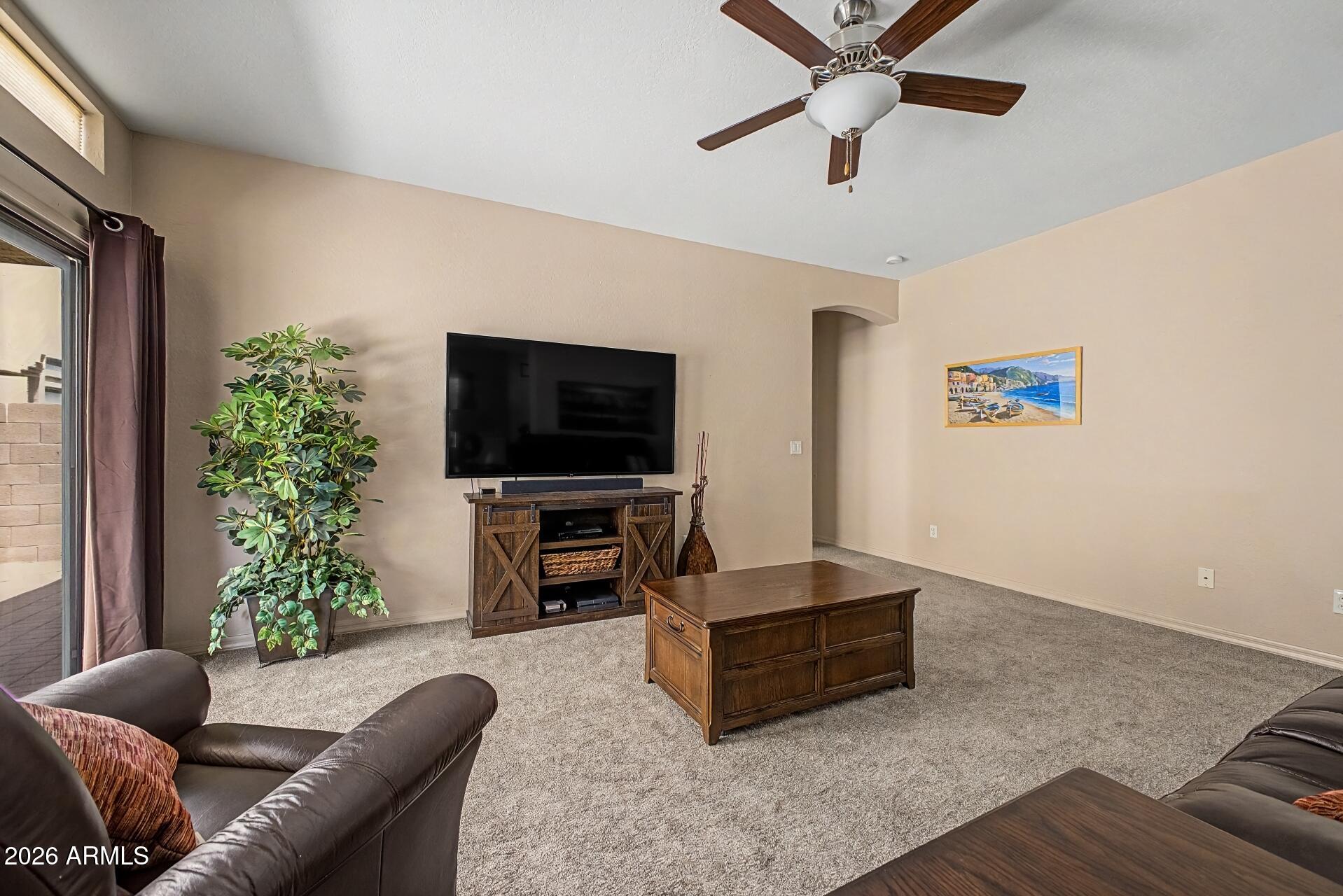 1650 South Crismon Road, Unit 25 Mesa, AZ 85209 - Photo 6 of 33 a living room with furniture and a flat screen tv