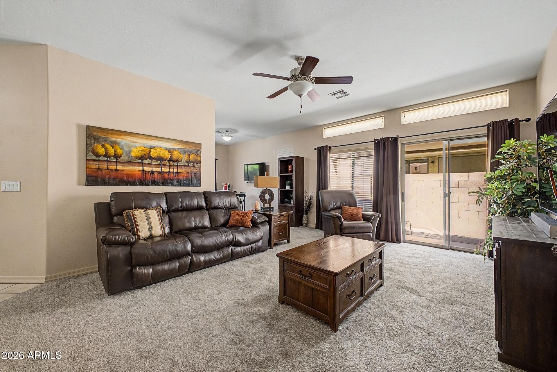 1650 South Crismon Road, Unit 25 Mesa, AZ 85209 - Photo 7 of 33 a living room with furniture and a large window
