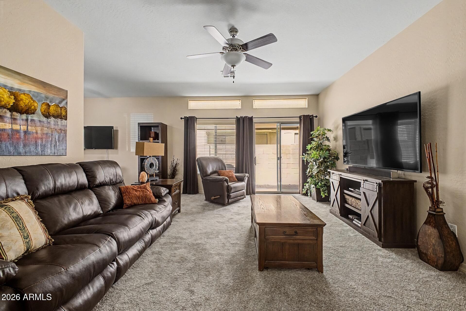 1650 South Crismon Road, Unit 25 Mesa, AZ 85209 - Photo 8 of 33 a living room with furniture and a flat screen tv