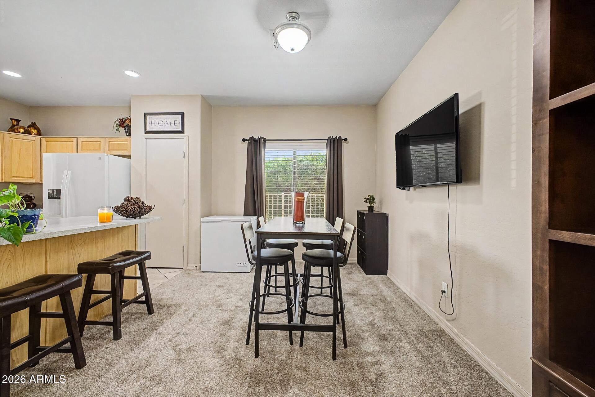 1650 South Crismon Road, Unit 25 Mesa, AZ 85209 - Photo 9 of 33 a view of a dining room with furniture
