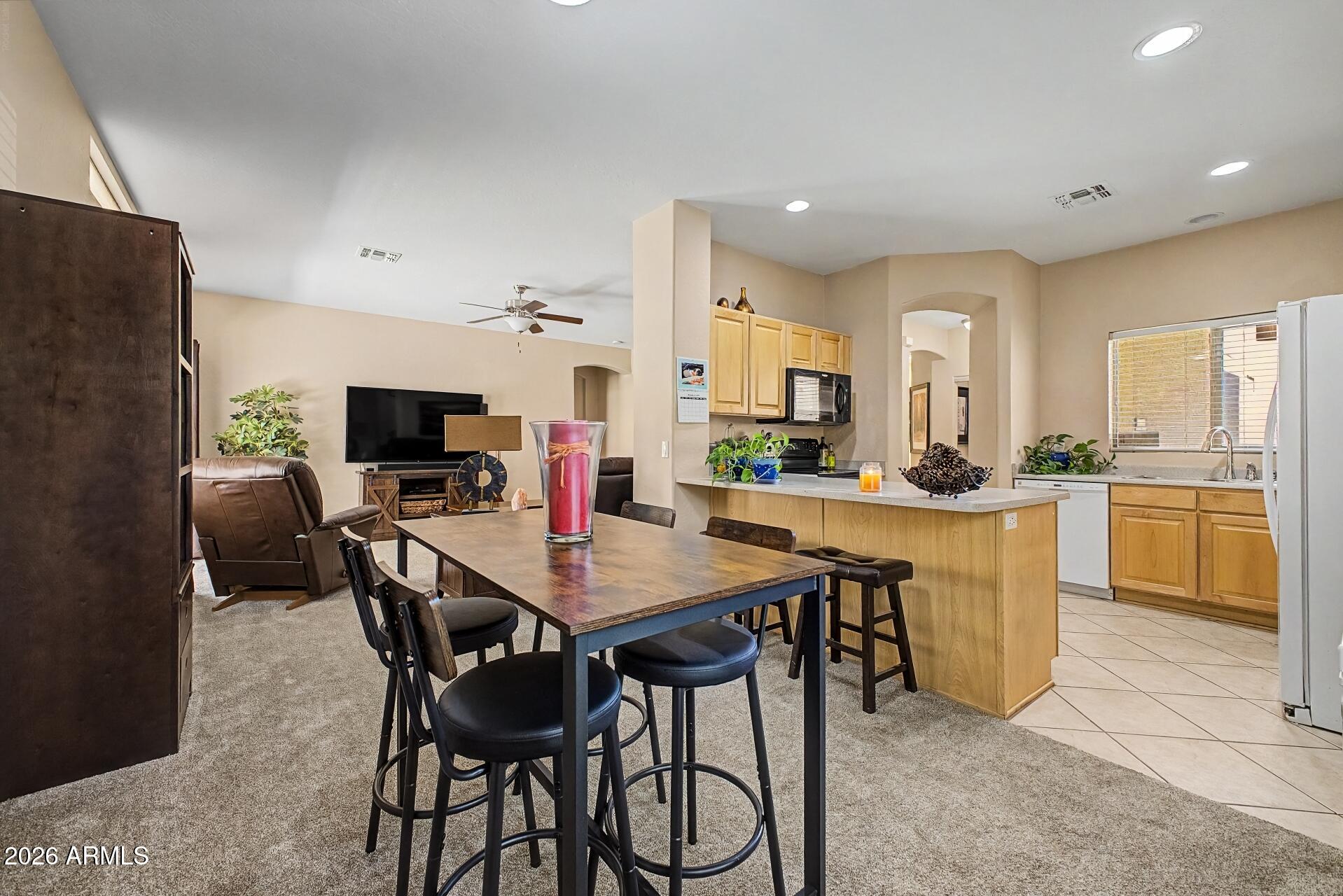 1650 South Crismon Road, Unit 25 Mesa, AZ 85209 - Photo 10 of 33 a view of a dining room with furniture and a kitchen