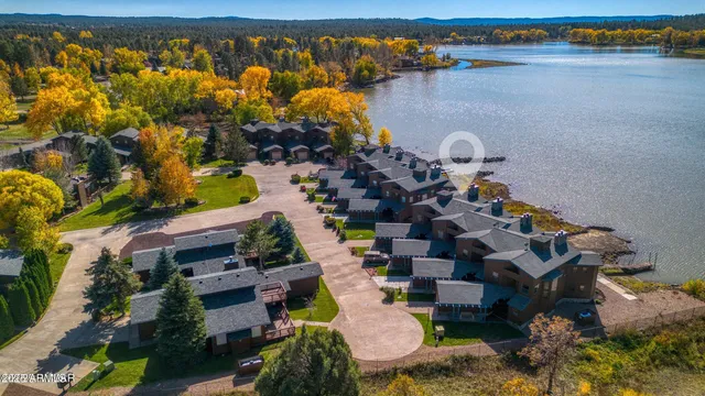 an aerial view of multiple house with a lake view