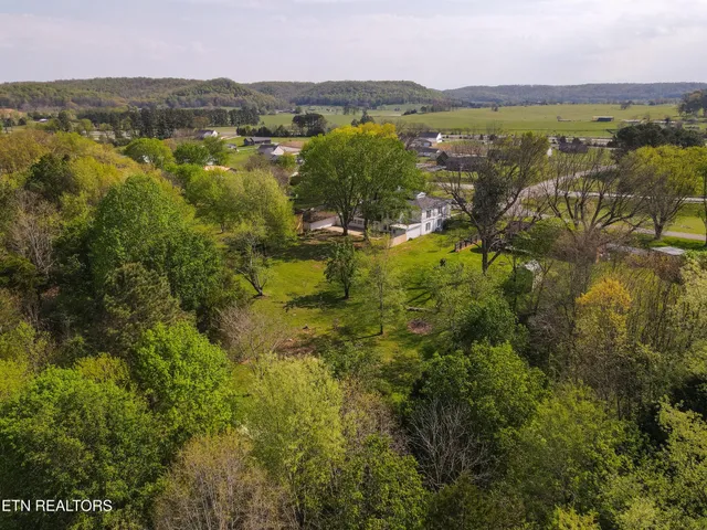 an aerial view of a house with a yard basket ball court and outdoor seating