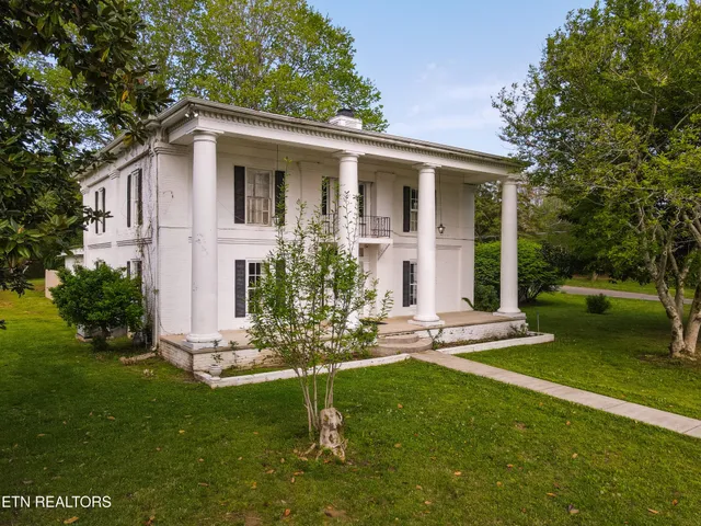 a view of a house with a yard and sitting area