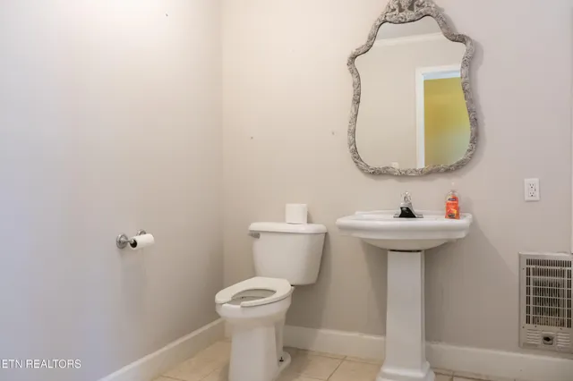 a view of a livingroom with a fireplace and window