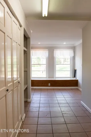 a room with walk in closet and wooden floor
