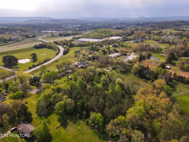 an aerial view of residential houses with outdoor space and river