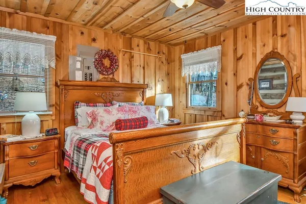 a bedroom with a bed and a dresser with the shoe rack