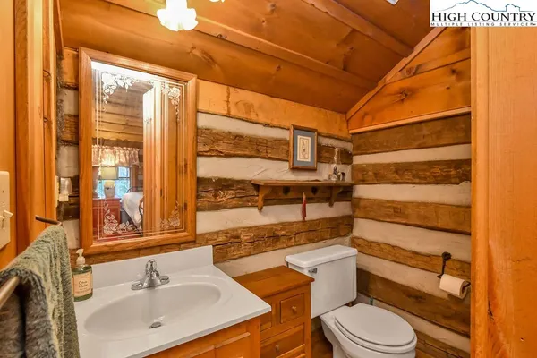 a bathroom with a sink toilet vanity and shower