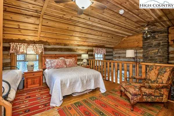 a bedroom with furniture and wooden floor