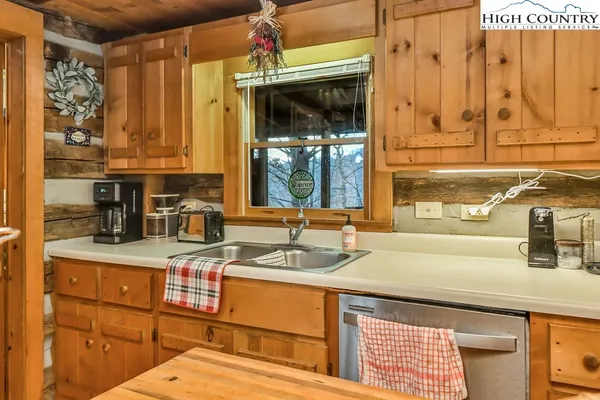 a kitchen with stainless steel appliances granite countertop a sink and a cabinets