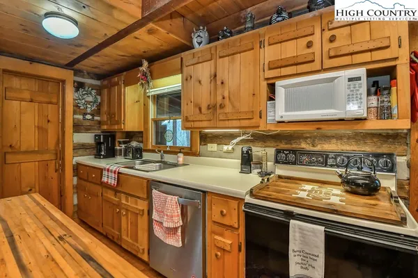 a kitchen with stainless steel appliances granite countertop a sink and cabinets