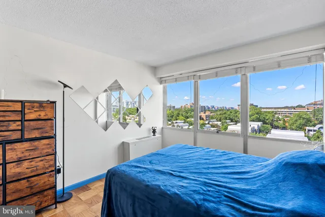 a bed room with a bed and a large window