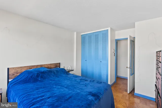 a view of bedroom with a bed and wooden floor
