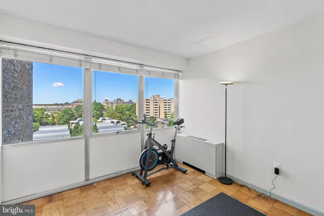 a view of a workspace with furniture and a window