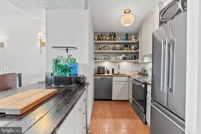 a kitchen with a refrigerator and a stove