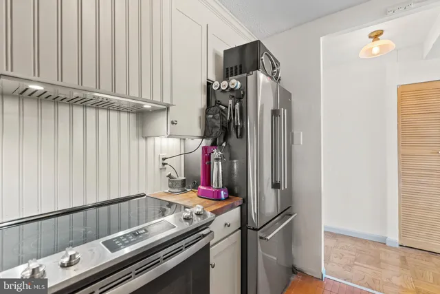 a view of walk in closet with clothes
