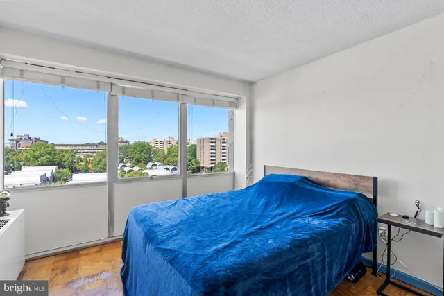 a bed sitting in a bedroom next to a window