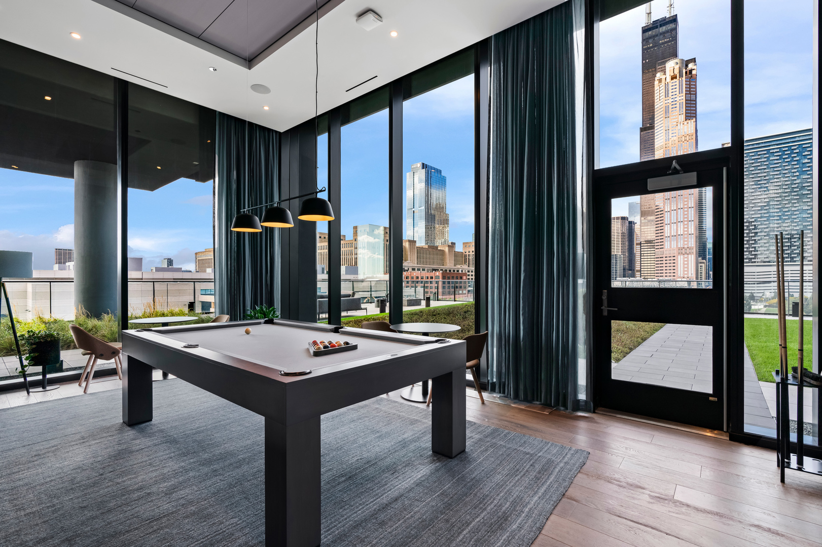 234 West Polk Street, Unit 3411 Chicago, IL 60607 - Photo 17 of 37 a room with pool table and windows